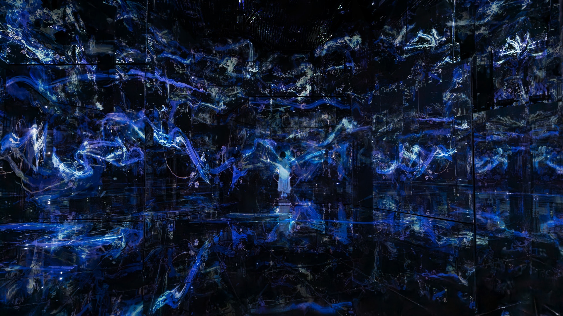 A lady mesmerized whilst looking at the Continuous trajectories in flux and form artwork