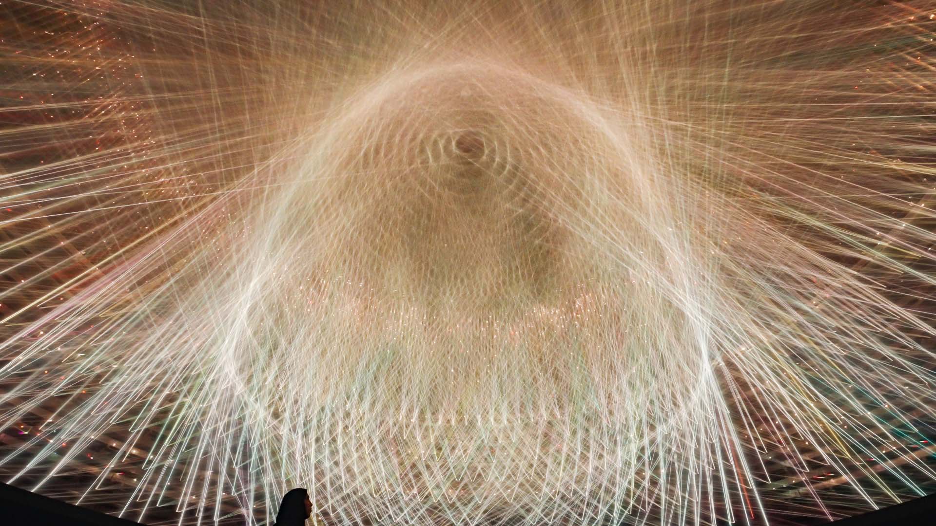 Yellowish white ray of laser light from Light Vortex artwork
