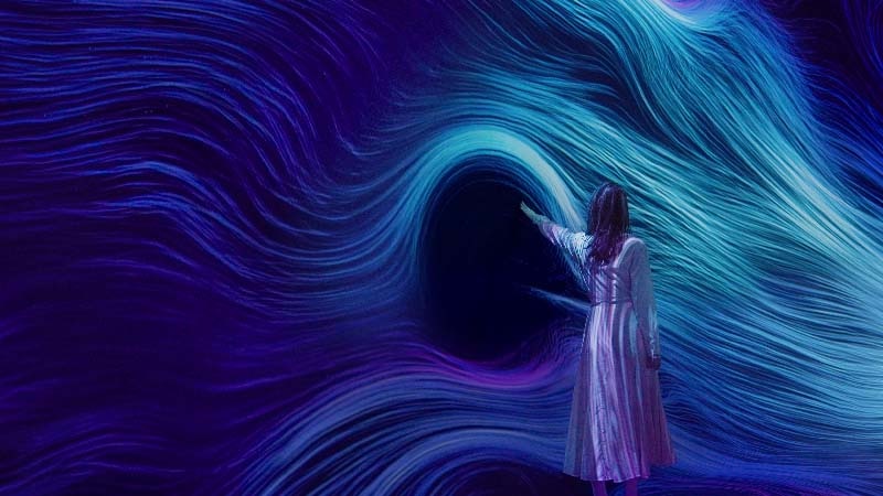 A lady interacting with Wind Form artwork