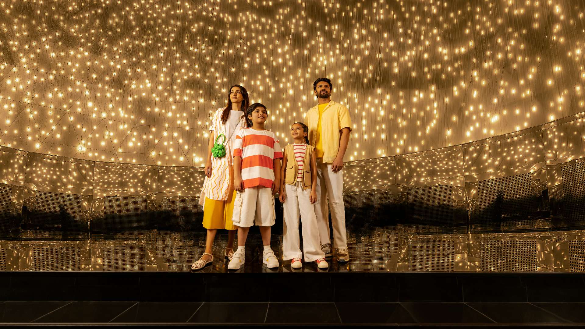 An Indian family of 4 experiencing Massless Suns and Dark Suns artwork.