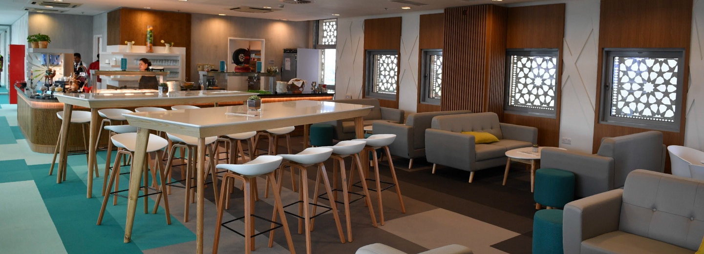 The interior of Yas Suite - West, with tables and stool-style seating at Yas Marina Circuit.