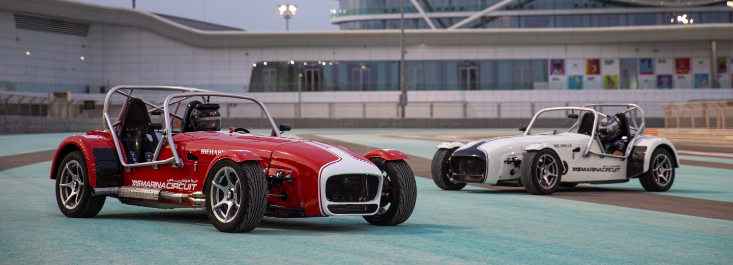 Two Caterham Seven's parked on the track at Yas Marina Cicuit as part of the Drive experience.