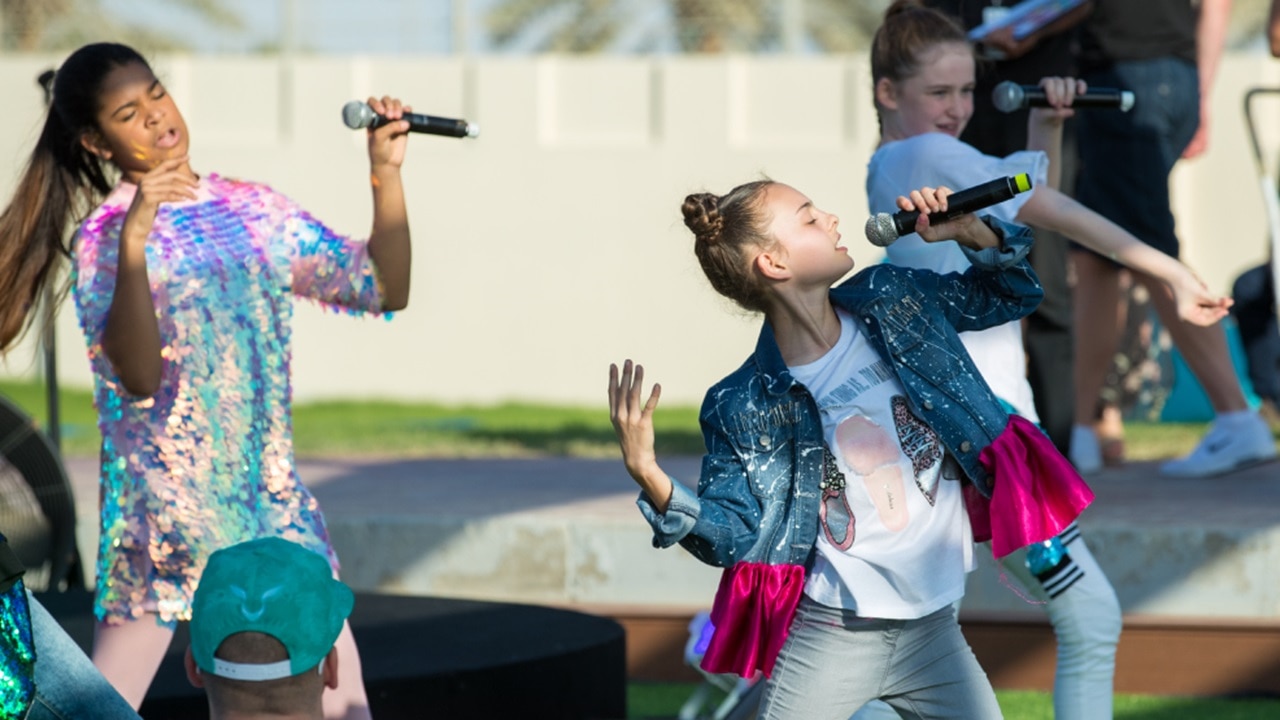 Girls singing at Yas Theme Park