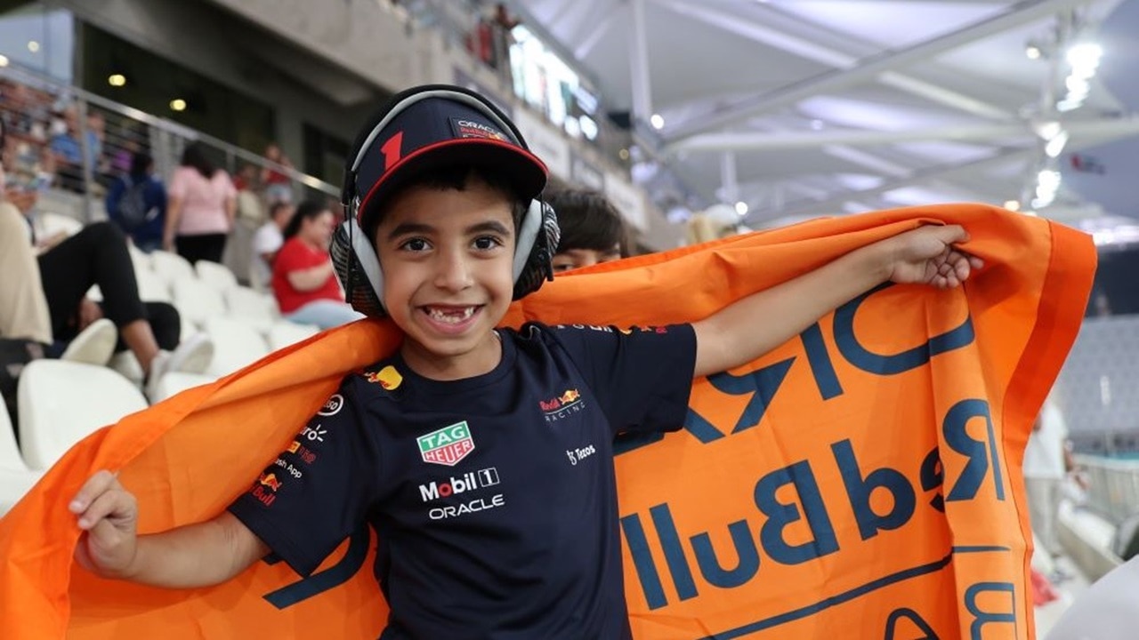 Girl takes picture with F1 Car Banner