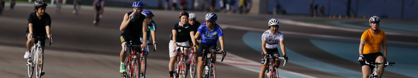 Numerous cyclists on the track at Yas Marina Circuit