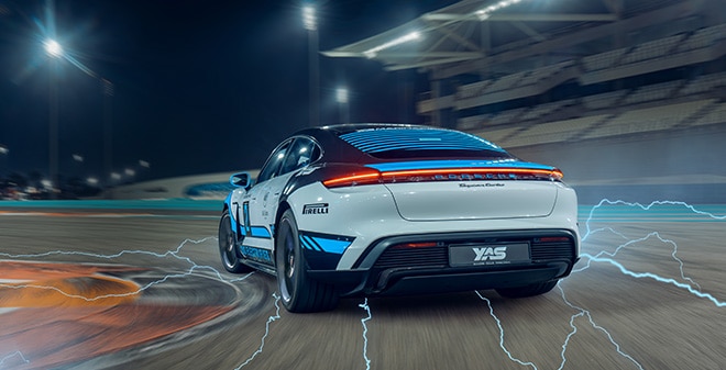 All-electric Porsche Taycan Turbo driving on the track at Yas Marina Circuit